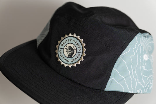 Black cap with a logo on a gray background