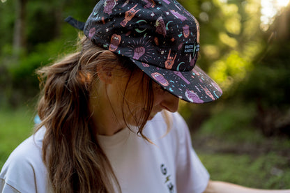 Person wearing a patterned cap in a natural setting